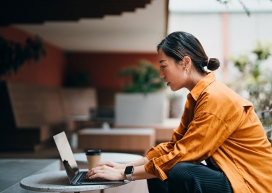 Woman Watching a Video on her laptop outside